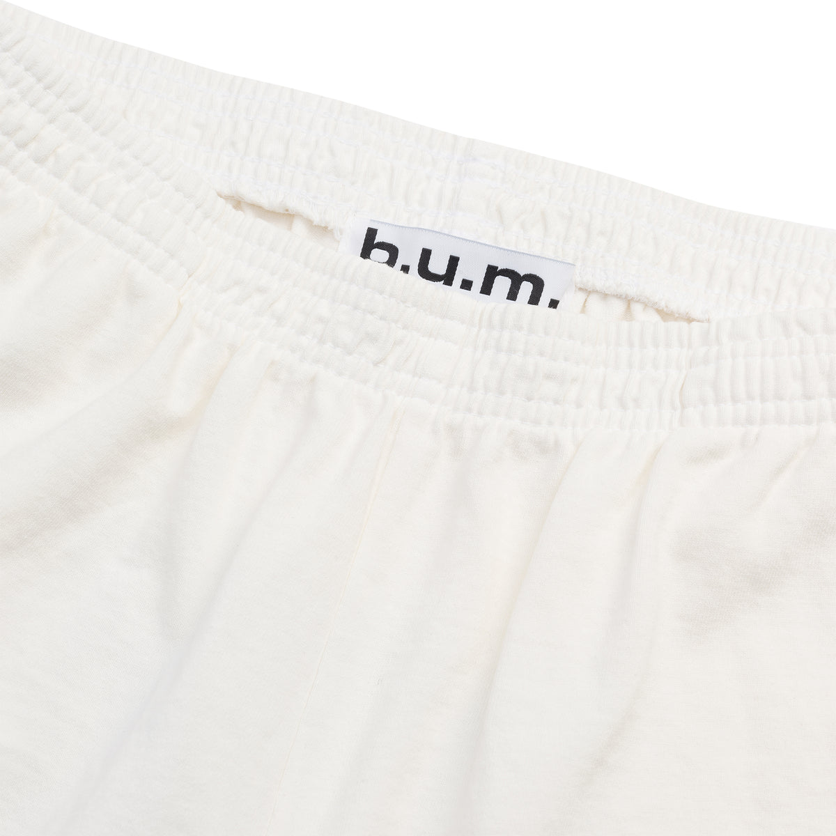Womens B.U.M. Equipment garment dyed shorts in off-white, showing the elastic waistband and side pocket