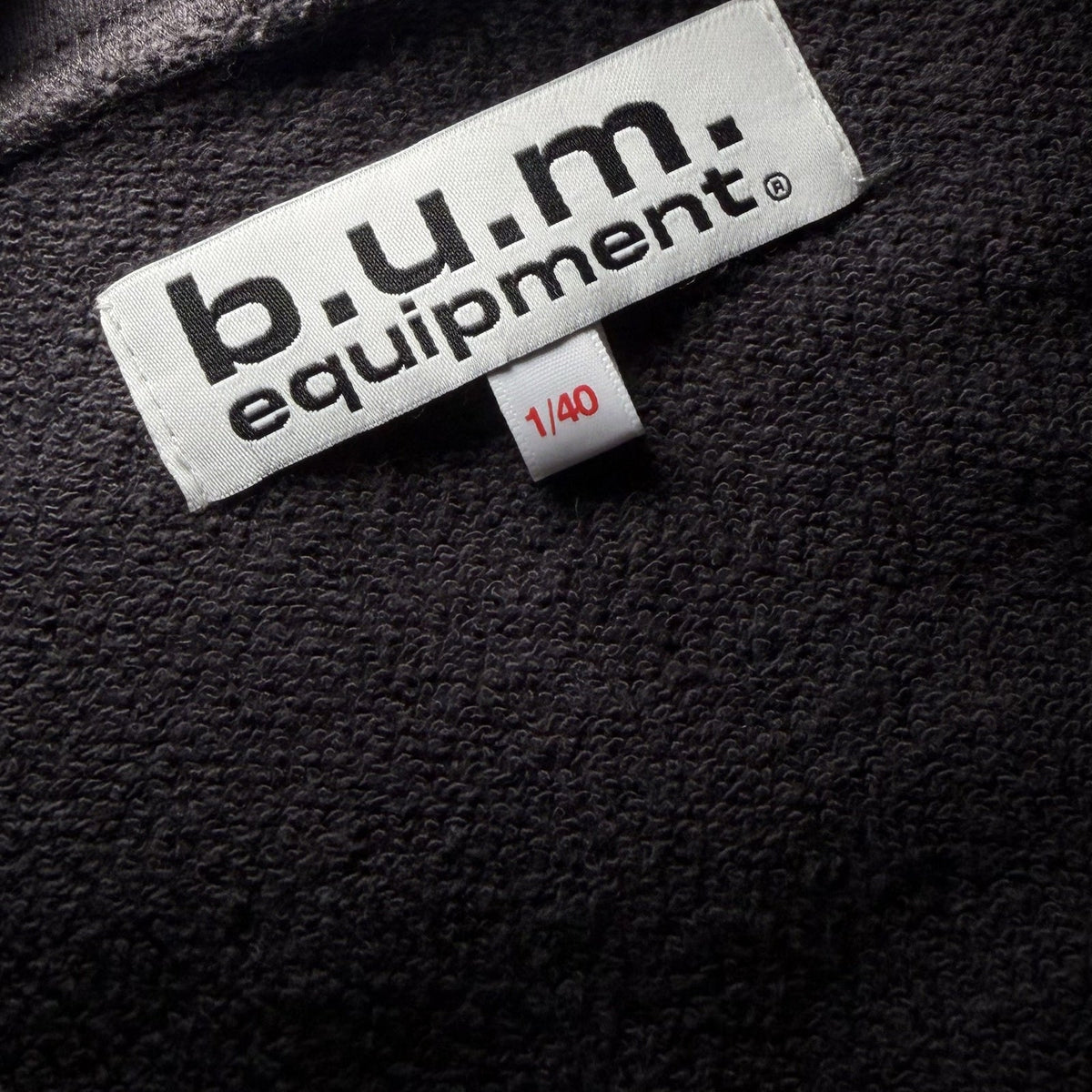 Woven b.u.m. equipment neck label with the individually numbered 1/40 tag