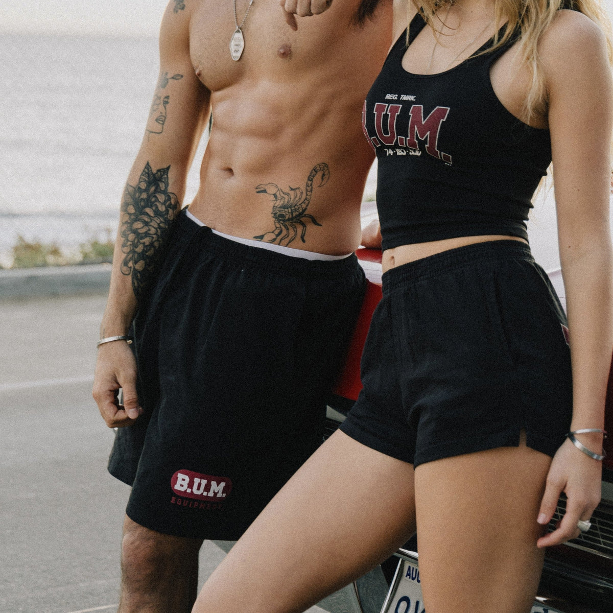 Man wearing the B.U.M. Mens Shorts in black with the B.U.M. Equipment badge on the leg